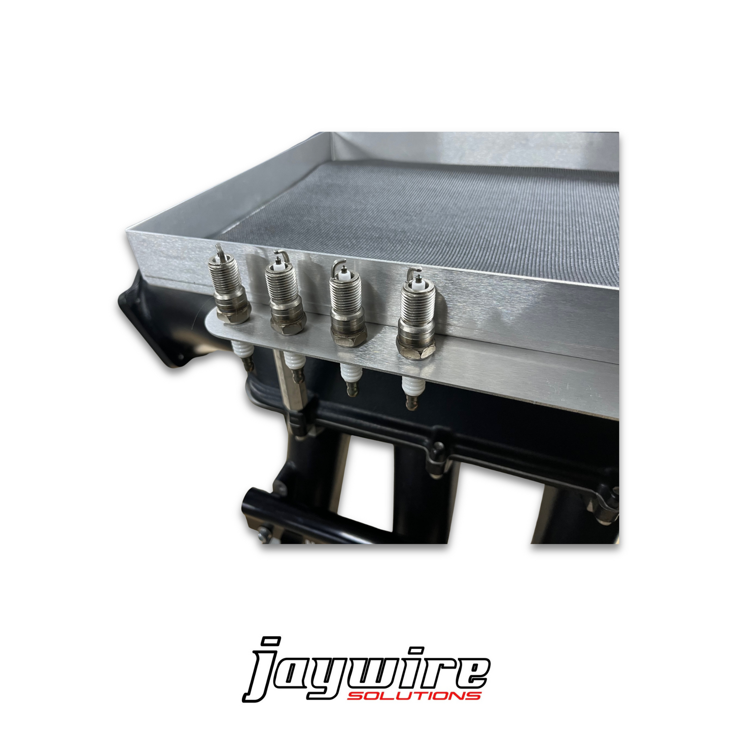 Metallic engine component with bolts on a white background, featuring the 'jaywire solutions' logo.
