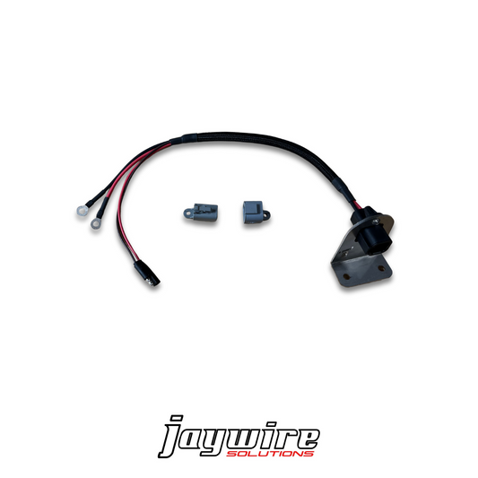 An image showing the components of the SnowEx Helixx Spinner Harness, including wiring and metal connectors, against a white background with the 'Joywire Solutions' logo.